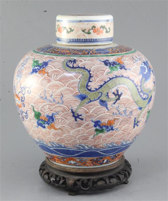 A Chinese doucai dragon ovoid jar and cover, Yongzheng four character mark but 19th century, height 24.5cm excl. wood stand